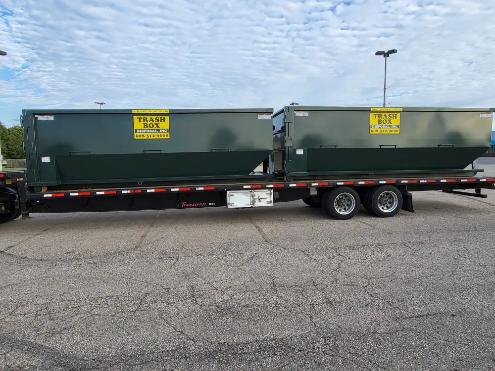 Two Dumpsters on a trailer tuck